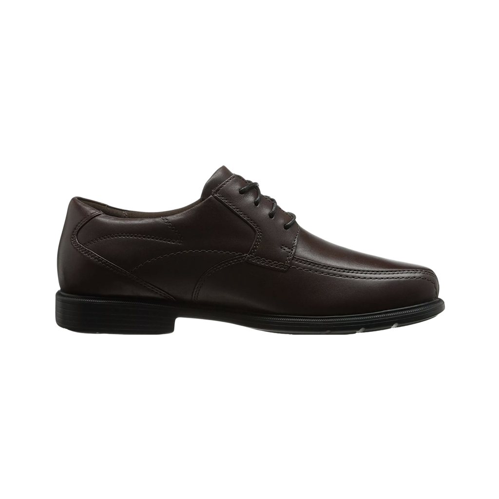 Dunham Men’s Douglas Bike Front Oxford in Brown featuring a full-grain leather upper, sleek bike-toe silhouette, secure lace-up closure, removable memory foam footbed, Stability R-Bar® technology, nylon shank, EVA midsole, and slip-resistant rubber outsole designed to blend professional style with supportive all-day comfort.