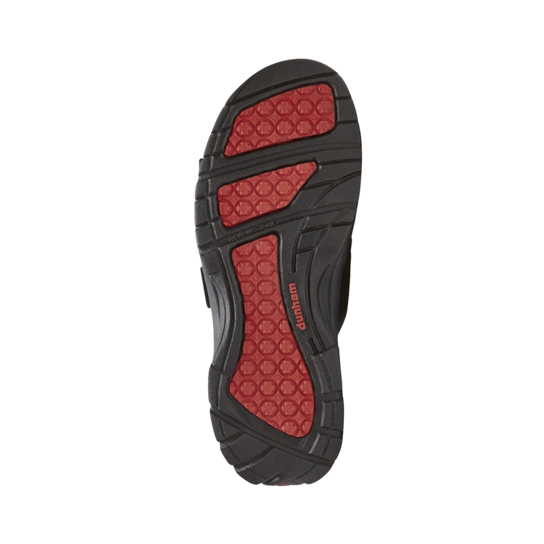 Bottom outsole view of the Dunham Men’s Newport Waterproof Slide in Black featuring the slip-resistant rubber outsole engineered to provide reliable traction on wet and dry surfaces while the nylon shank, EVA midsole, and supportive construction help provide comfort for conditions such as plantar fasciitis, heel pain, flat feet, overpronation, arthritis, joint pain, bunions, diabetic-sensitive feet, and general foot fatigue.
