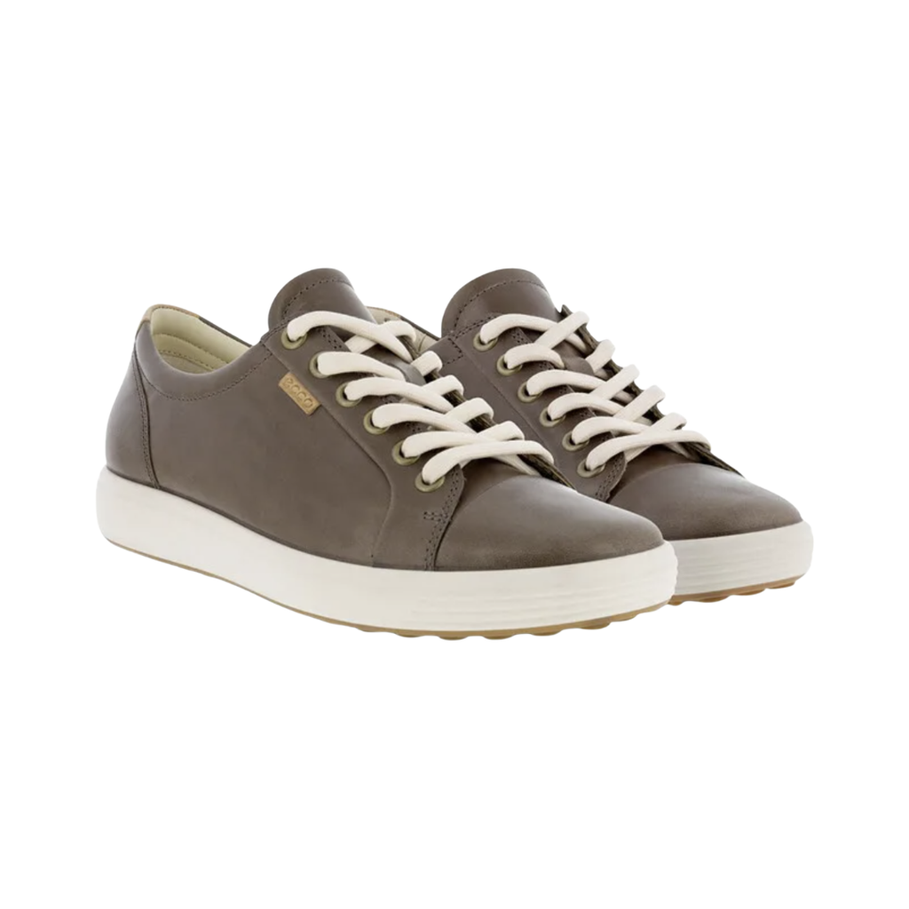 ECCO Women’s Soft 7 Sneaker in Taupe featuring a premium leather upper, full lace-up closure, FLUIDFORM™ Direct Comfort Technology, removable leather-covered insole, breathable textile lining, and durable PU/TPU outsole designed for clean Scandinavian style and supportive everyday comfort.