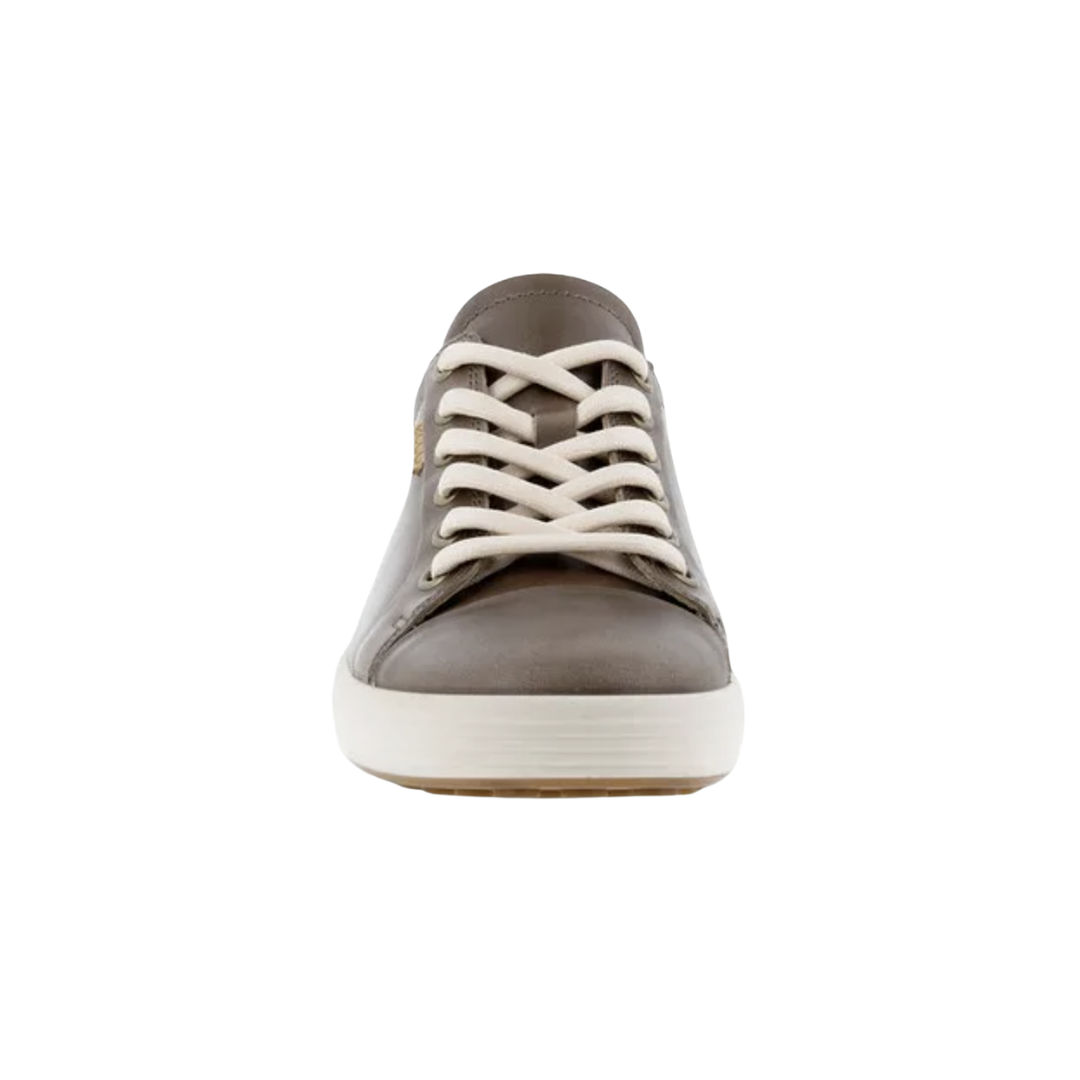 Front view of the ECCO Women’s Soft 7 Sneaker in Taupe showcasing the smooth leather upper, rounded toe, full lace-up closure, and minimalist silhouette designed for a secure fit and comfortable everyday wear.