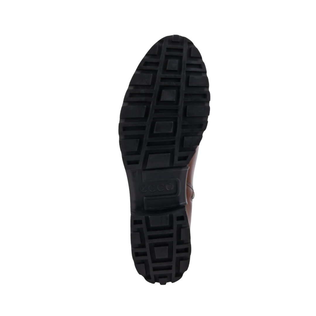 Bottom outsole view of the ECCO Women’s Modtray Ankle Boot in Cognac featuring the chunky lugged rubber outsole engineered to provide excellent traction and stability on slick streets and uneven terrain while FLUIDFORM™ Direct Comfort Technology provides flexible cushioning and support for conditions such as plantar fasciitis, flat feet, overpronation, heel pain, joint pain, bunions, forefoot pain, and general foot fatigue.