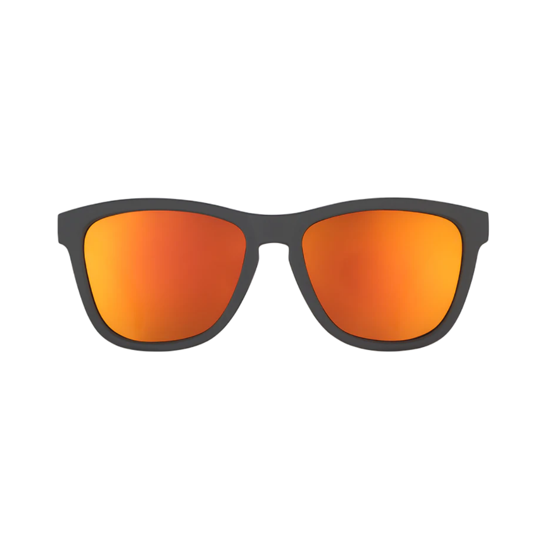 Front view of the Goodr OG "Whiskey Shots with Satan" sunglasses showcasing the classic rounded silhouette, matte black frame, and blazing red-orange reflective polarized lenses with UV400 protection.