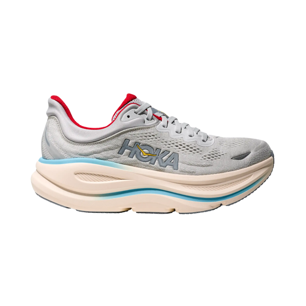 Side view of the HOKA Women’s Bondi 9 in Cosmic Grey/Stardust, showcasing the thick super critically foamed EVA midsole, smooth MetaRocker™ profile, and breathable recycled polyester upper for maximum cushioned support.