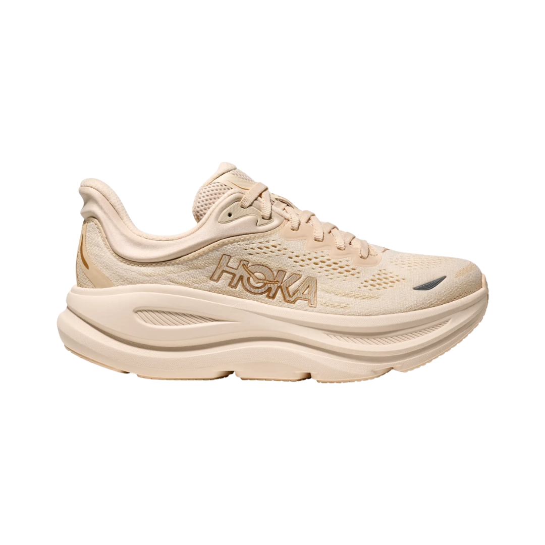 Side view of the HOKA Women’s Bondi 9 in Vanilla/Birch, showcasing the thick super critically foamed EVA midsole, smooth MetaRocker™ profile, and breathable recycled polyester upper for maximum cushioned support.