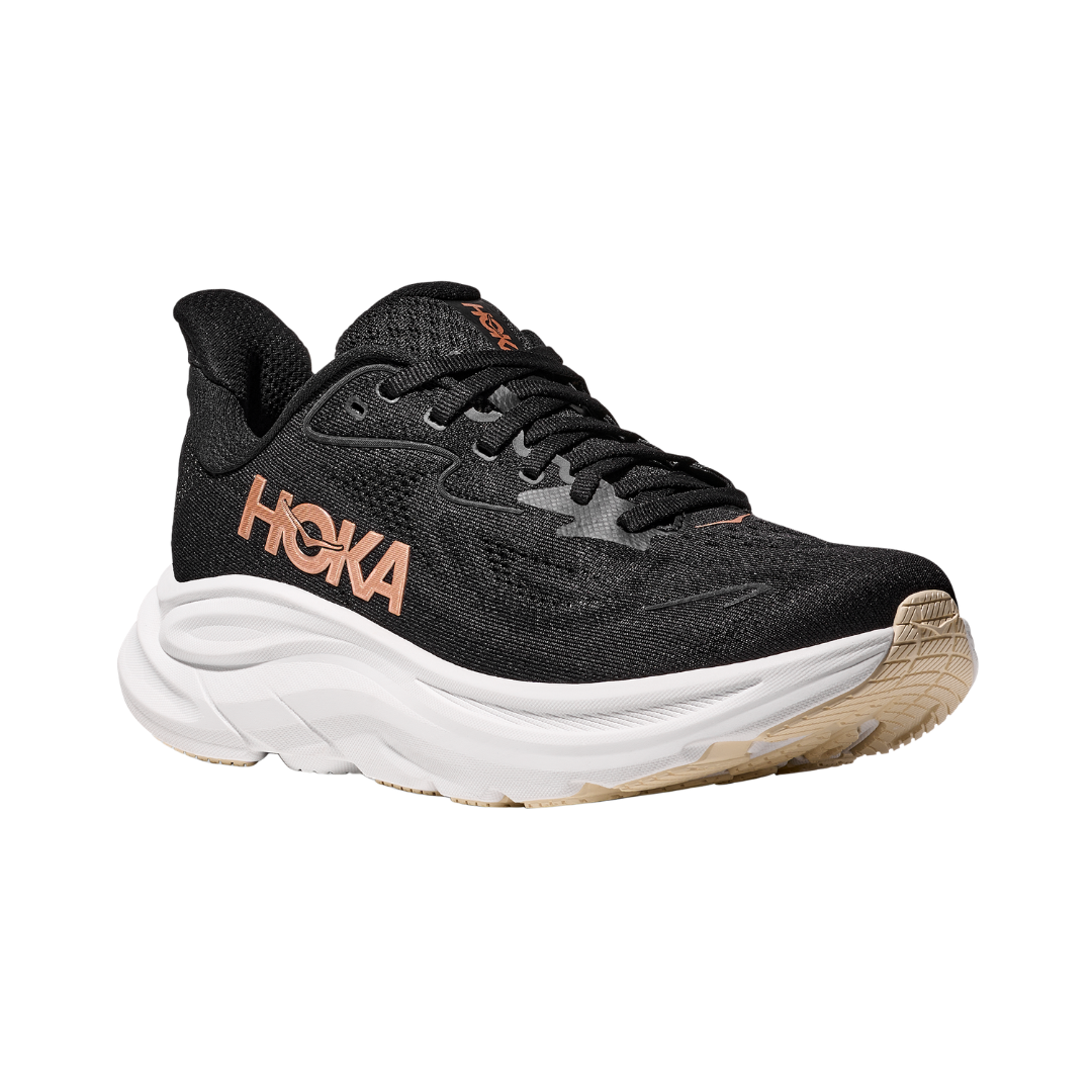 Side view of the HOKA Women’s Clifton 10 in Black/Rose Gold, showcasing the lightweight jacquard knit upper, plush CMEVA midsole cushioning, and smooth MetaRocker™ geometry for a soft, efficient ride.