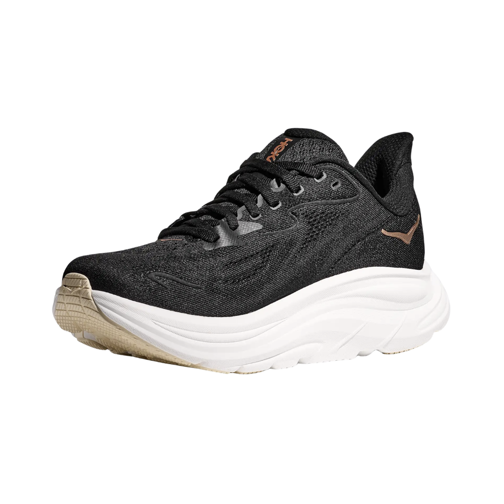 Side view of the HOKA Women’s Clifton 10 in Black/Rose Gold, showcasing the lightweight jacquard knit upper, plush CMEVA midsole cushioning, and smooth MetaRocker™ geometry for a soft, efficient ride.