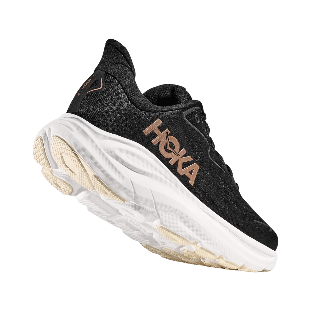 Bottom heel view of the HOKA Women’s Clifton 10 in Black/Rose Gold, highlighting the durable outsole with traction zones designed for reliable grip and long-lasting performance.