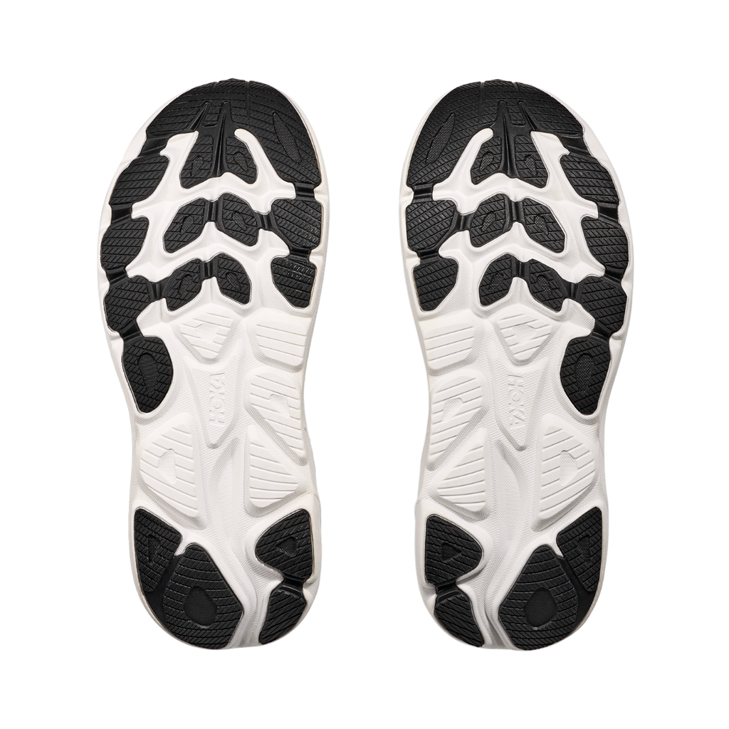 Bottom view of the HOKA Women’s Clifton 10 in Black/White, highlighting the durable outsole with traction zones designed for reliable grip and long-lasting performance.