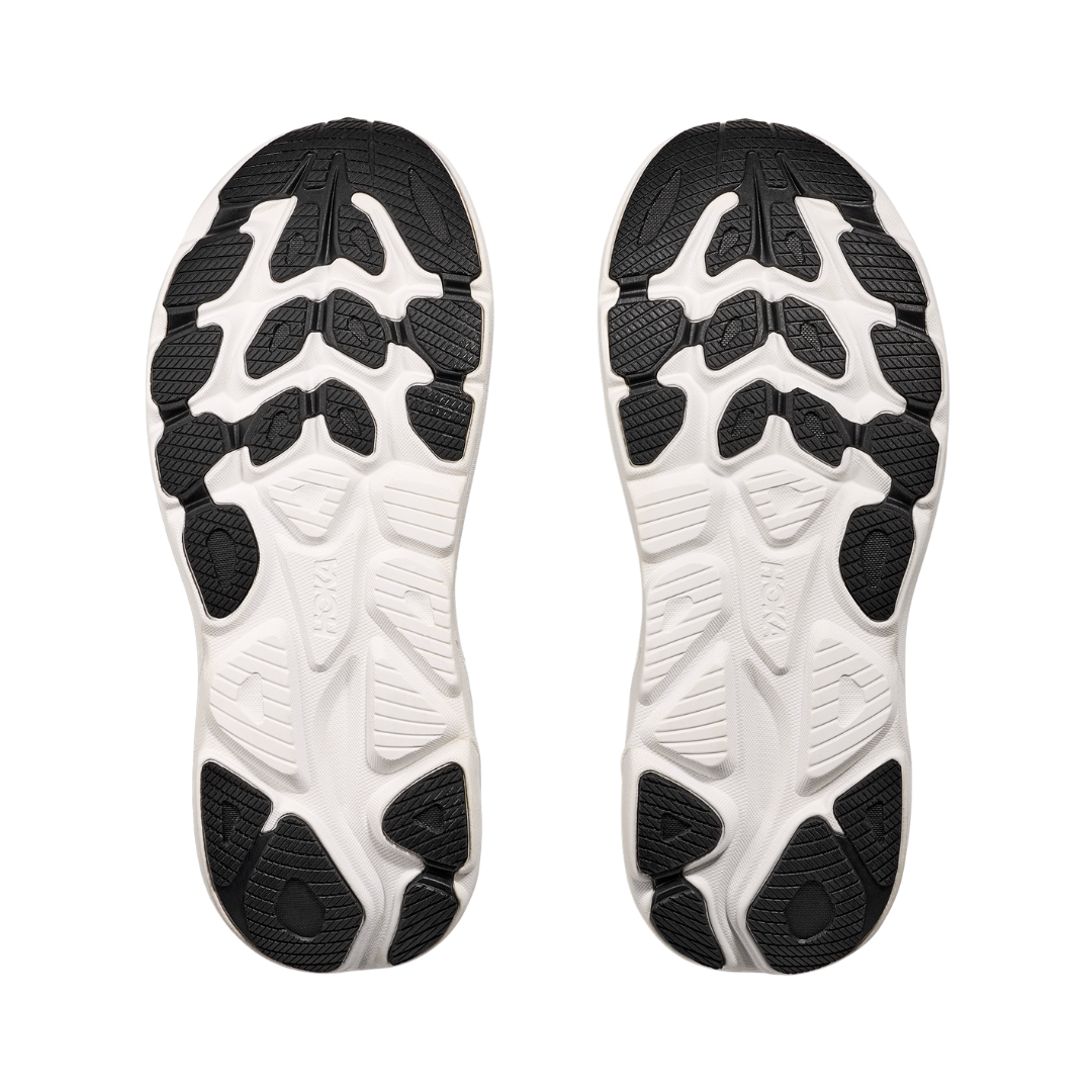Bottom view of the HOKA Women’s Clifton 10 in Black/White, highlighting the durable outsole with traction zones designed for reliable grip and long-lasting performance.