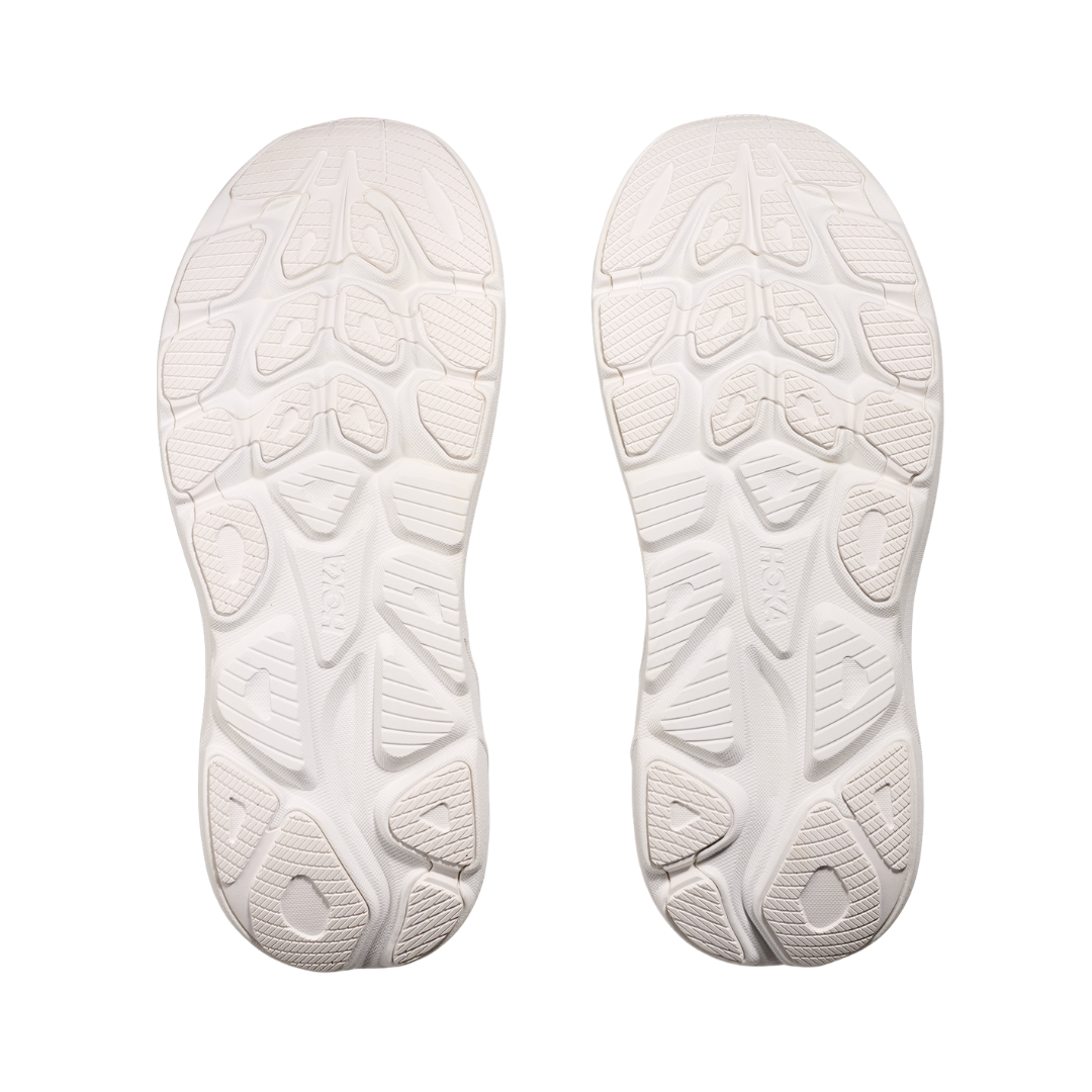 Bottom view of the HOKA Women’s Clifton 10 in White/White, highlighting the durable outsole with traction zones designed for reliable grip and long-lasting performance.