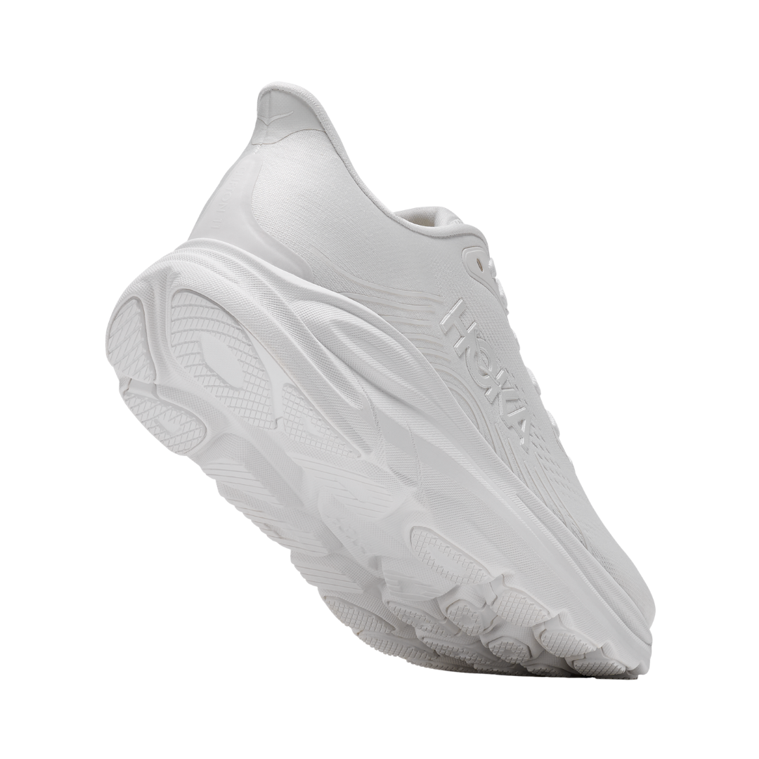 Rear view of the Women's HOKA Clifton 11 in White/White highlighting the cushioned heel, Rearfoot-Focused Active Foot Frame™, reflective details, and durable abrasion rubber outsole designed to provide stability and traction.