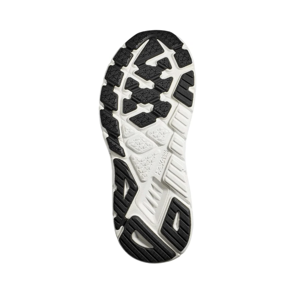 Bottom view of the Women's HOKA Arahi 7 in Black/White highlighting the durable rubber outsole designed to provide dependable grip, stability, and traction across everyday running and walking surfaces.