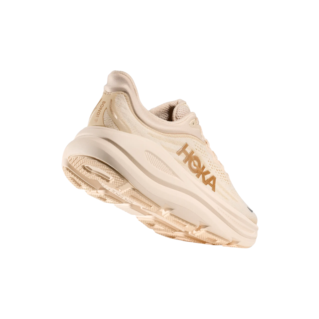 Bottom view of the HOKA Women’s Bondi 9 in Vanilla/Birch, highlighting the Durabrasion rubber outsole with high-wear traction zones for durability and reliable grip.