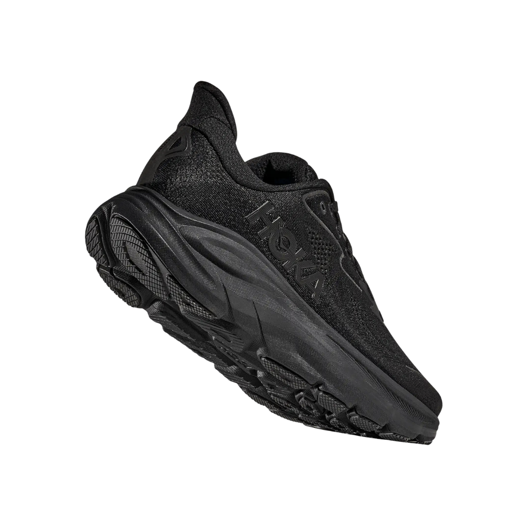 Bottom heel view of the HOKA Women’s Clifton 10 in Black/Black, highlighting the durable outsole with traction zones designed for reliable grip and long-lasting performance.