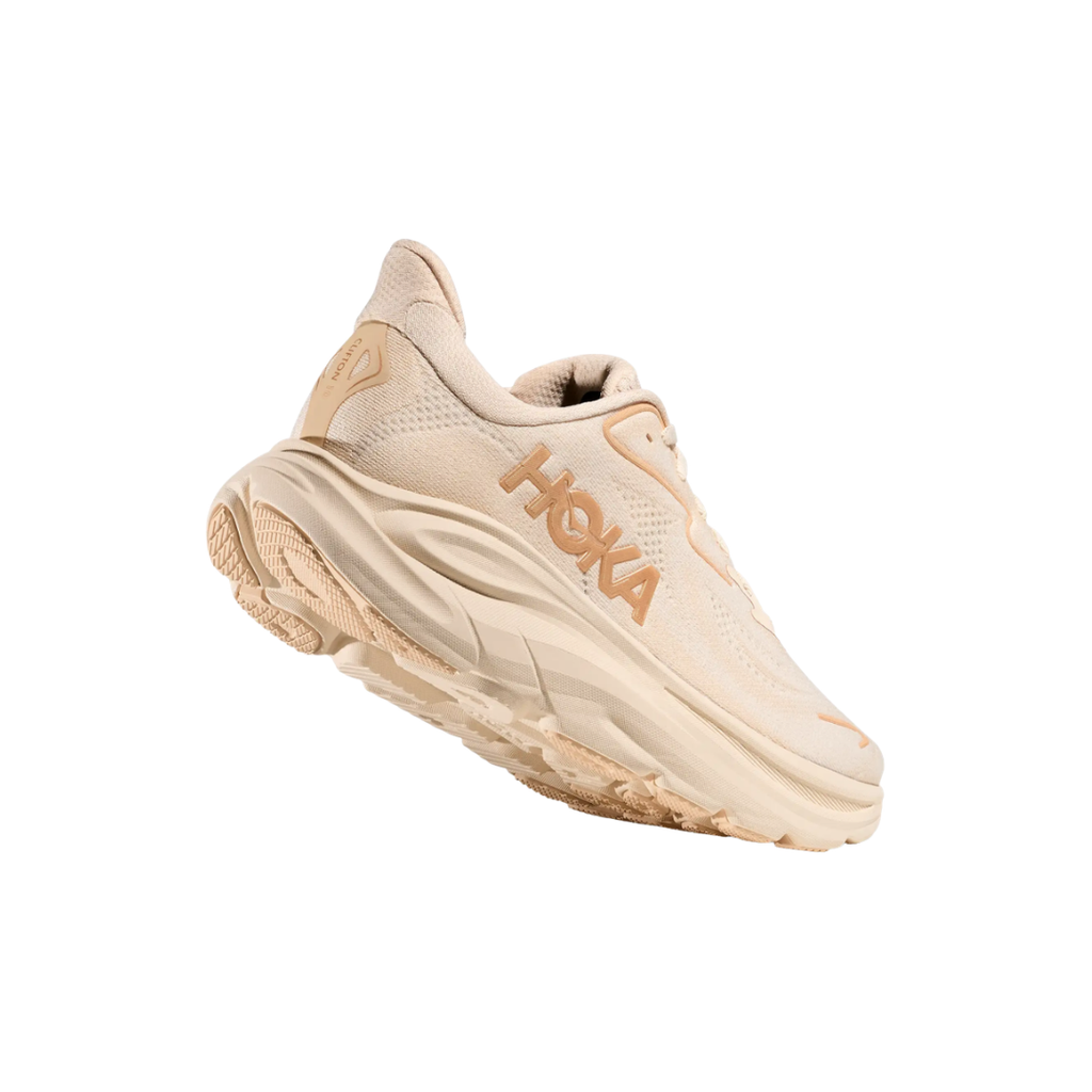 Bottom heel view of the HOKA Women’s Clifton 10 in Vanilla/Birch, highlighting the durable outsole with traction zones designed for reliable grip and long-lasting performance.