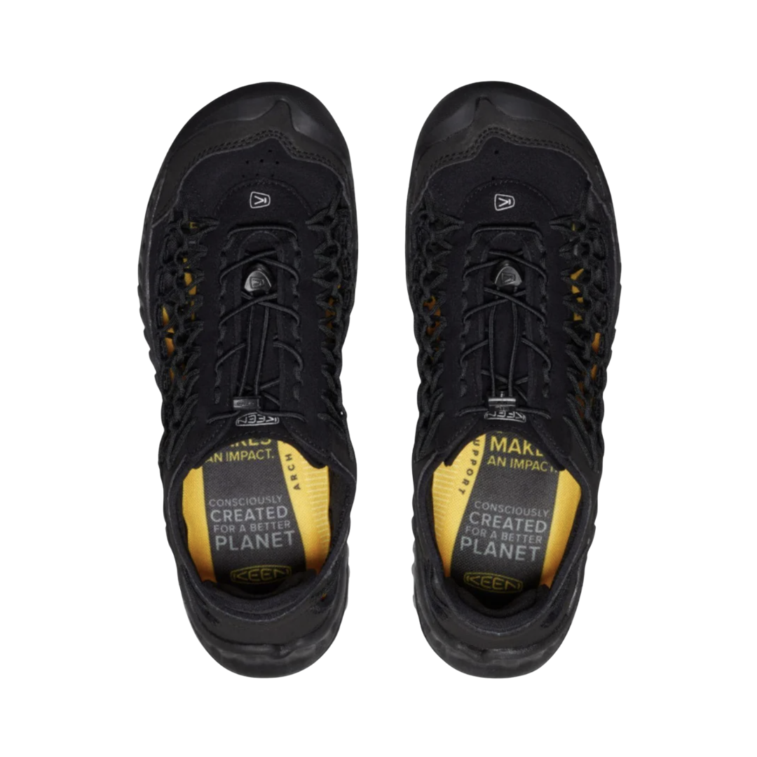 KEEN Men's Uneek NXIS Sandal in Triple Black displaying the distinctive two-cord design and contoured Metatomical footbed for natural arch support.