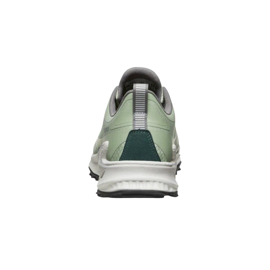Heel view of the KEEN Women's Zionic Waterproof Hiking Shoe in Desert Sage/Ember Glow, highlighting the KonnectFit heel-capture system designed to provide a secure fit and added stability on uneven terrain.