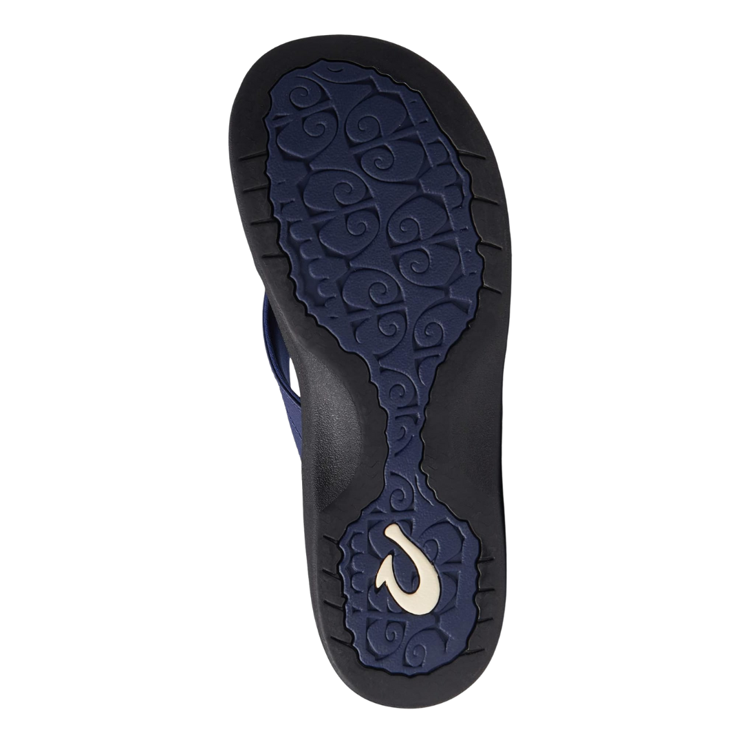 Bottom view of the Women’s Olukai ʻOhana in Pacifica/Black, showing the textured rubber outsole engineered for traction on wet or dry surfaces.